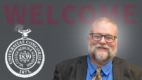 Portrait photo of John J. Folk, MD, EdD, Albany Medical College Associate Dean for Faculty Affairs nest to college seal logo.
