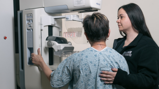 Woman conducting a mammogram.