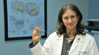 Alexandra Paul, MD, holds an example of the implantable Vivistim device.