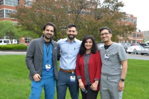 Four Nephrology fellows standing in front of a tree outside of Albany Medical Center