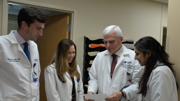 Residents confer with a doctor